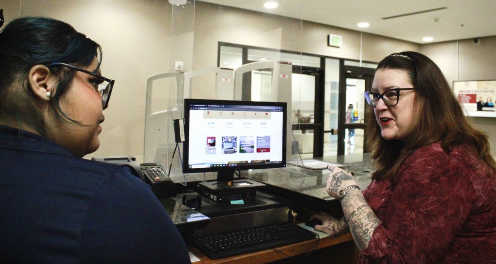 First-ever library dean works with a worker in the library