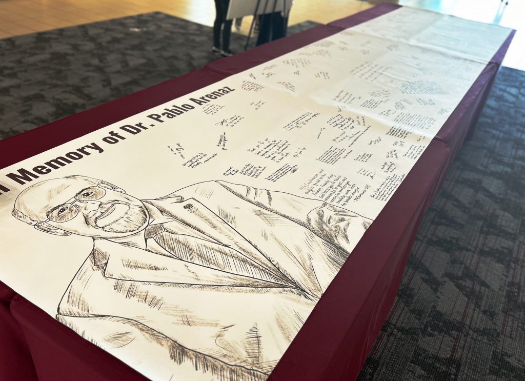 A banner bears signatures and memories from students to remember President Pablo Arenaz