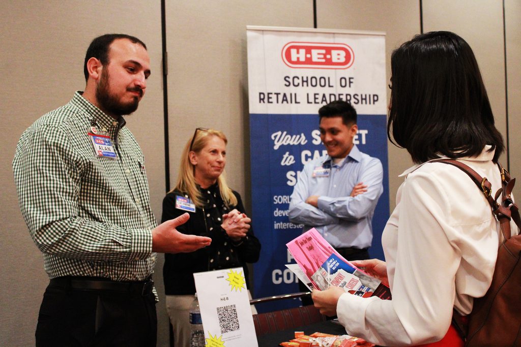 HEB representatives speak to students during a job fair.